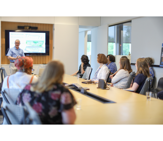 group of staff having a seating meeting at a conference table